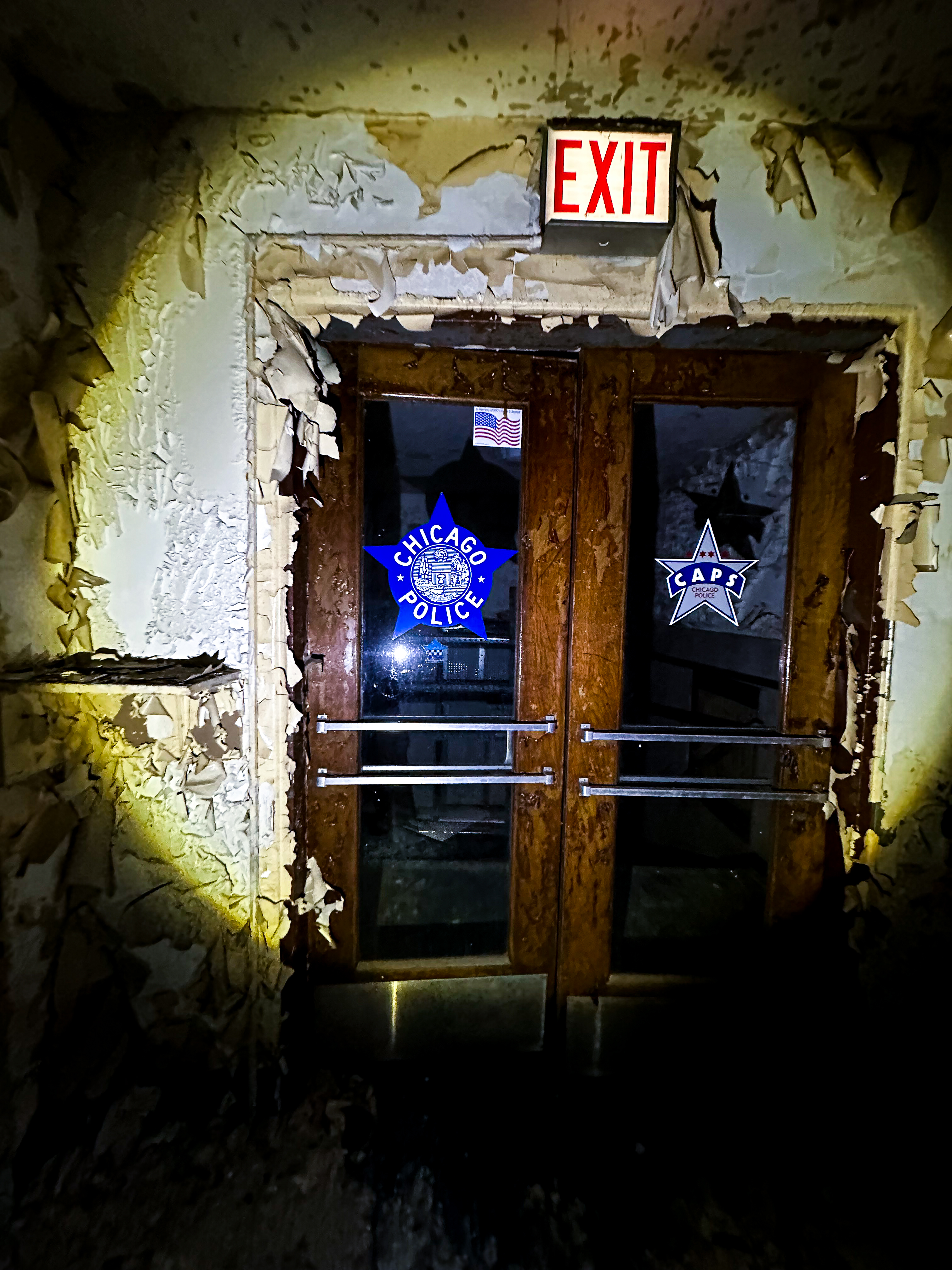 Chicago Police doors with peeling paint and EXIT sign above